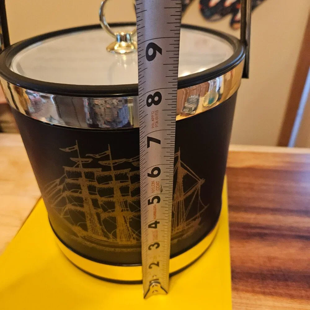 vintage ice bucket black with a sailboat design with a gold touch